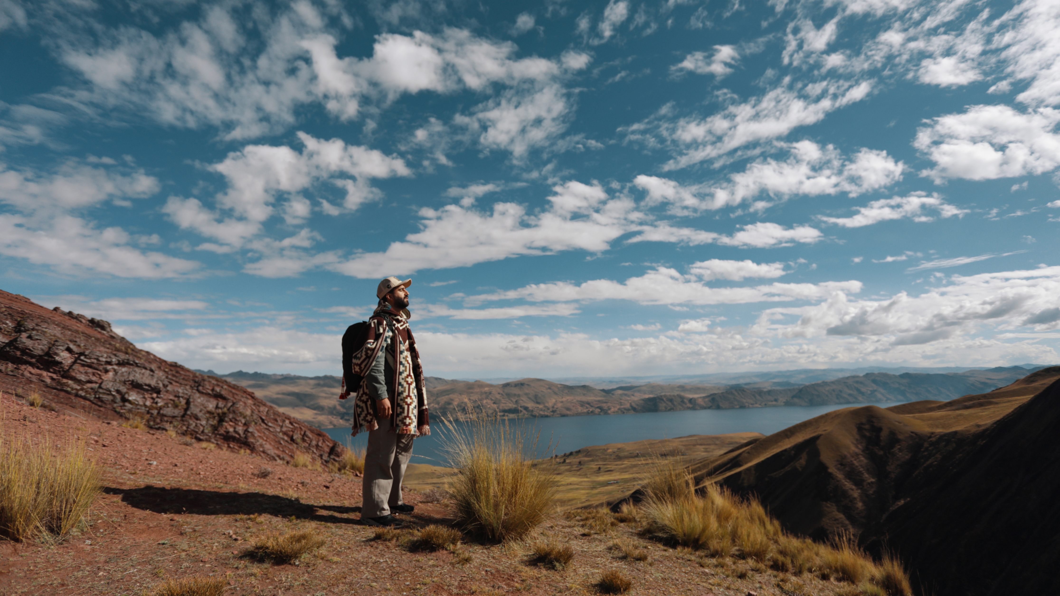 Hussein Salman looking out over an Andean mountain lake